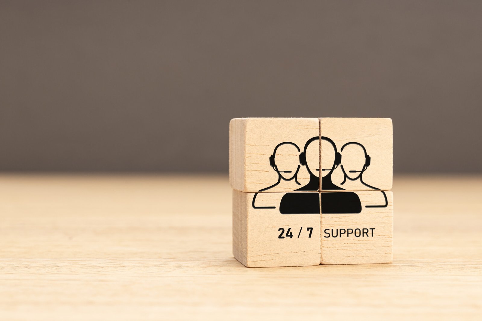 24-7 Customer support concept. Group of wooden block with Group of Call Center Workers icon. Copy space